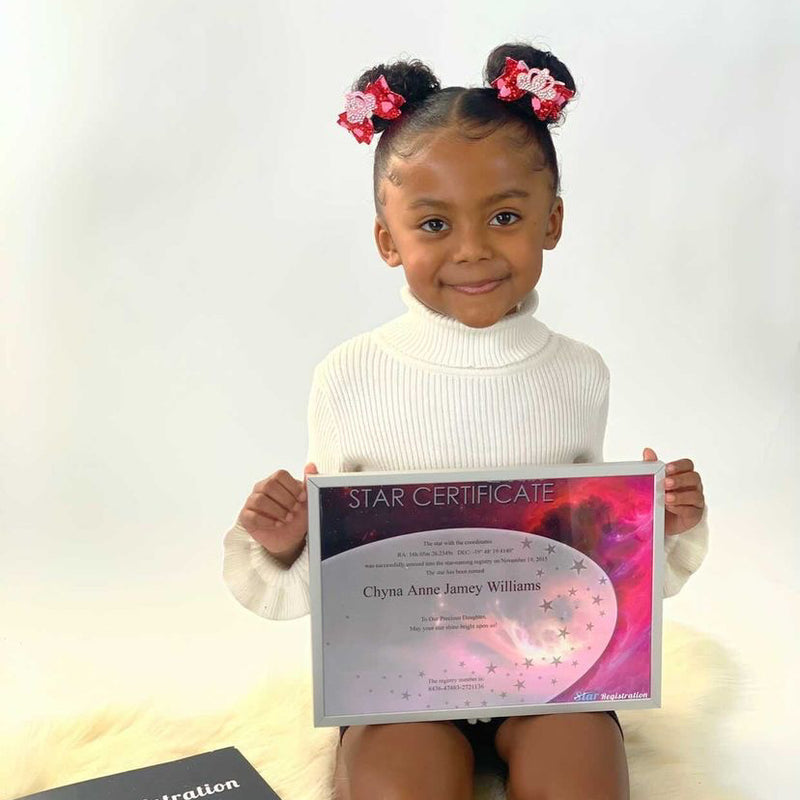 Child holding star certificate
