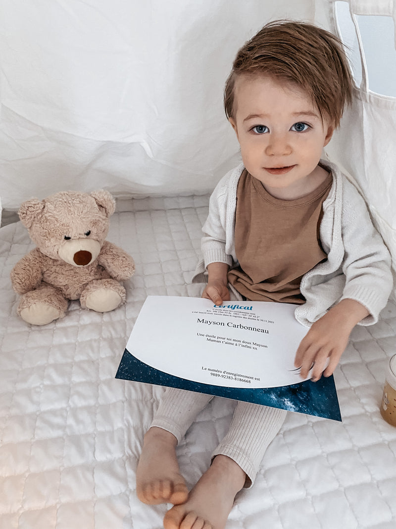 Young boy holding a star certificate in his hands