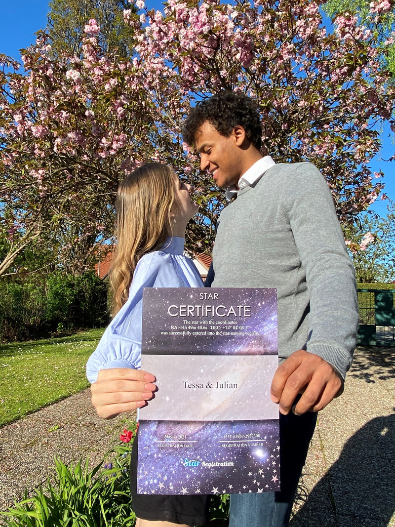 Couple holding their star certificate gift in the camera